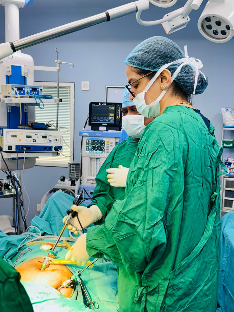Dr. Shachi Singh and surgical team performing laparoscopic surgery with patient monitoring equipment